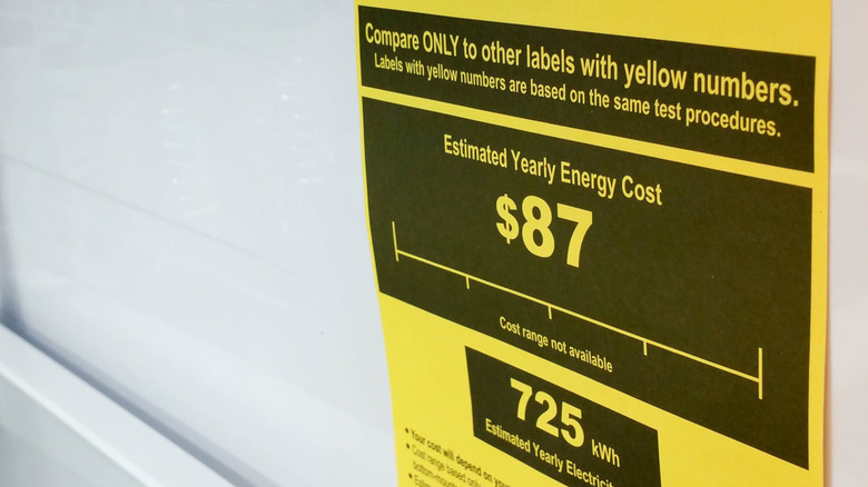 A close-up of a yellow EnergyGuide label on a refrigerator