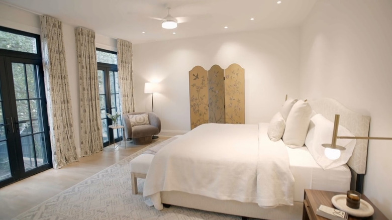 A large master bedroom with french doors.