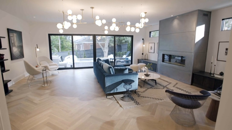 A modern living room with herringbone floors.