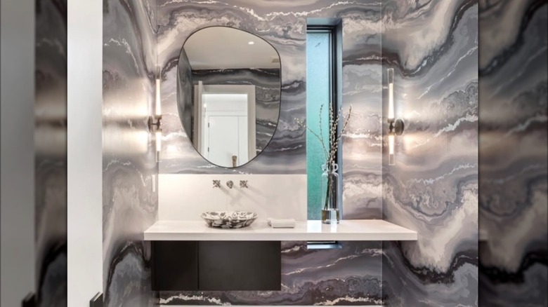 A modern bathroom with stone wallpaper.
