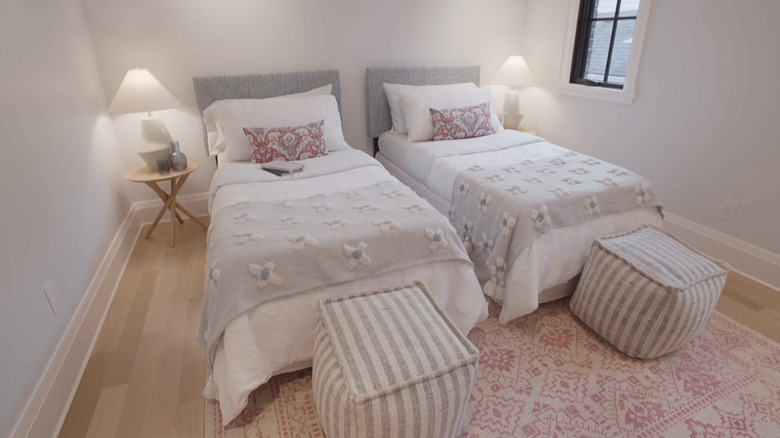 Two matching twin beds with gray bedding.