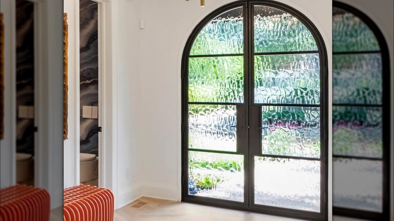 An arched front door with glass panels.