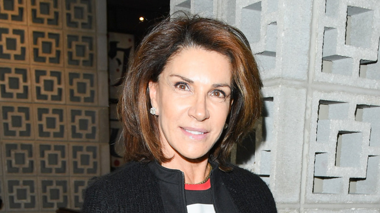 Hilary Farr posing in a silver dress.