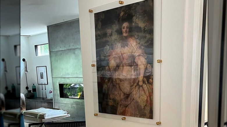 A vintage style painting behind acrylic glass.