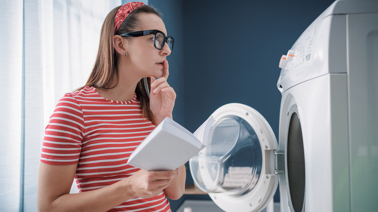 woman confused by washer settings