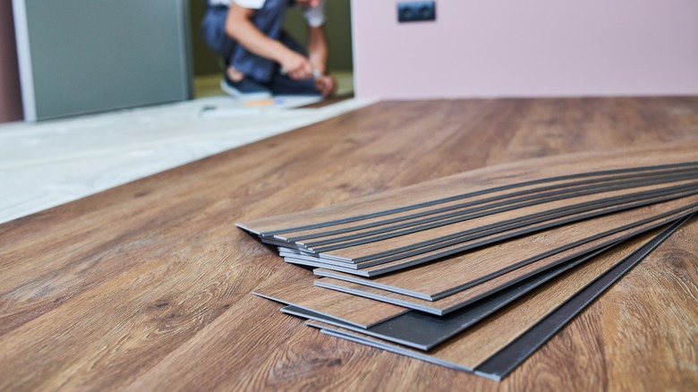 man installing hard wood floor