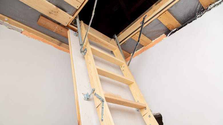 Unfolded wooden attic ladder 