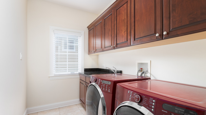 Laundry room with dark-colored wood cabinets