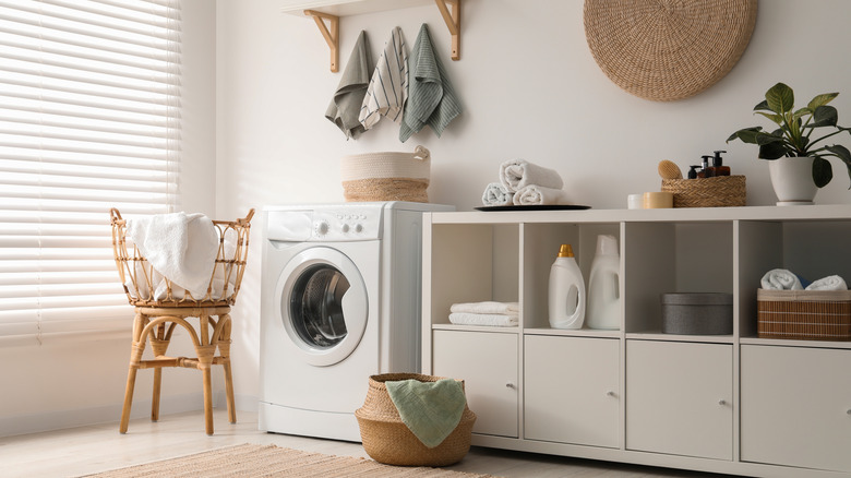 White laundry room with boho decor