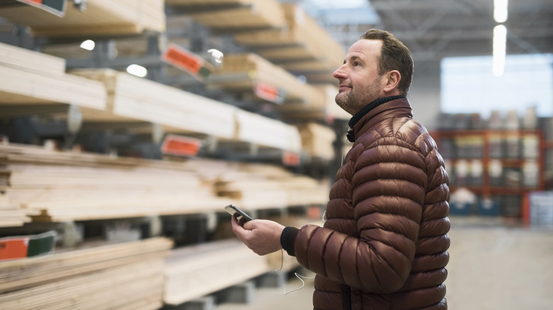 Person shopping for lumber at a store