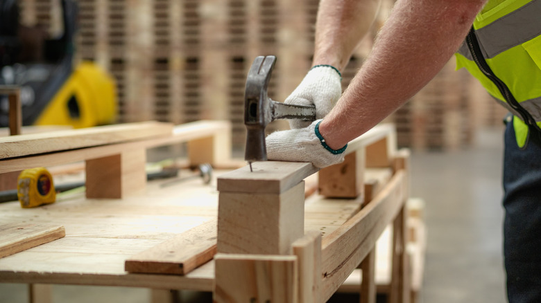 Man making wood pallets out of hardwood