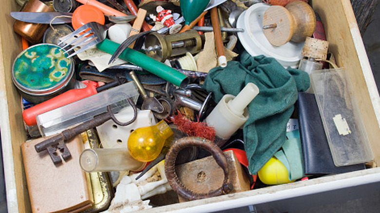 A drawer filled with various old, unused items