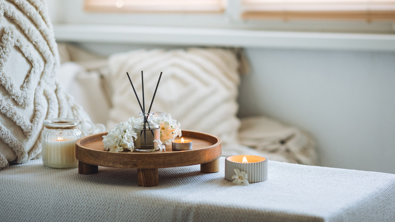 Candles and a scent diffuser in a cozy living room setting
