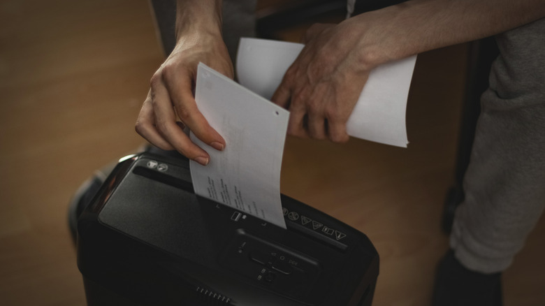 Close-up of a person shredding paperwork