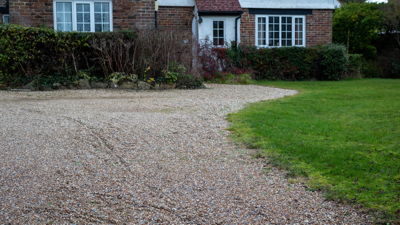 A gravel driveway in poor condition