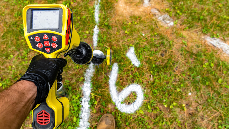 Person locating underground utility lines