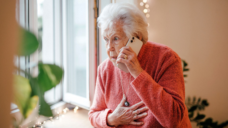 woman by window on phone