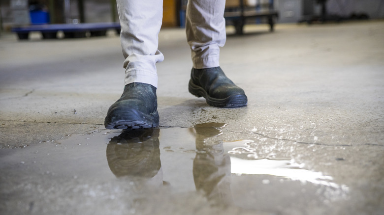 person in garage with water on floor