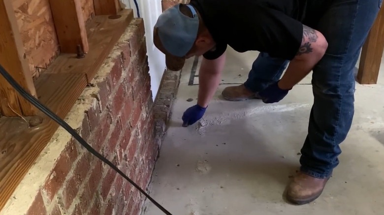 Professional applying termite treatments indoors