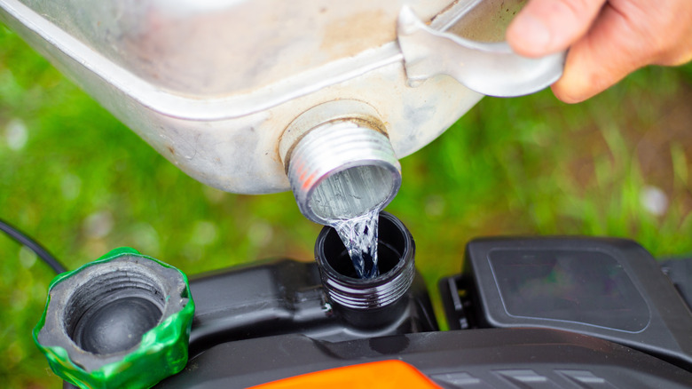Refilling a lawn mower with gasoline