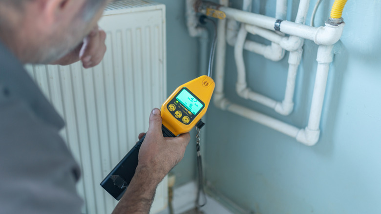 Technician using gas detector