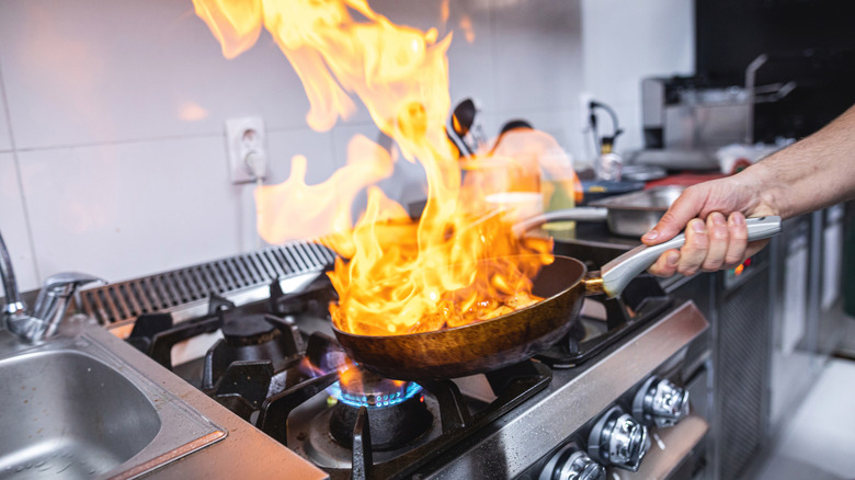Skilled chef preparing gourmet food at a restaurant kitchen.