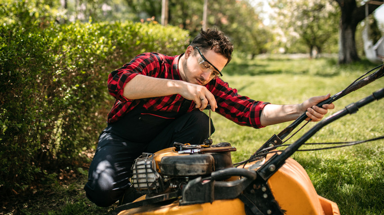 checking oil level on lawn mower