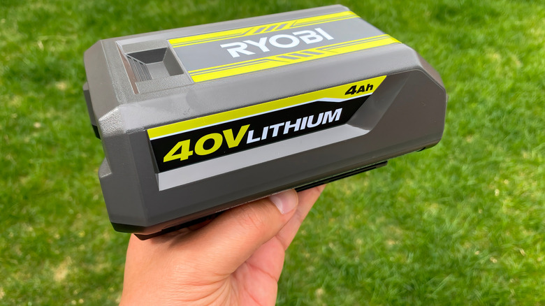 Person holding Ryobi rechargeable battery