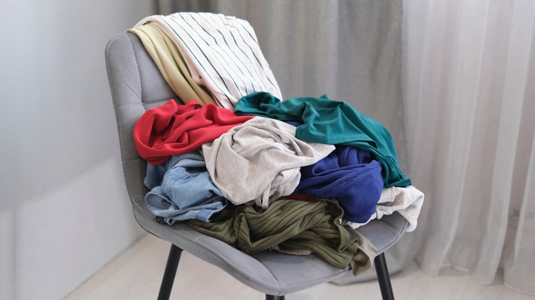 clothes piled on chair