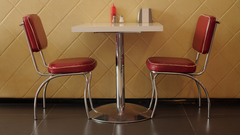 A mid century cafe set with two chairs.