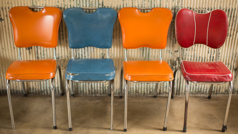 Four vintage vinyl dining chairs.