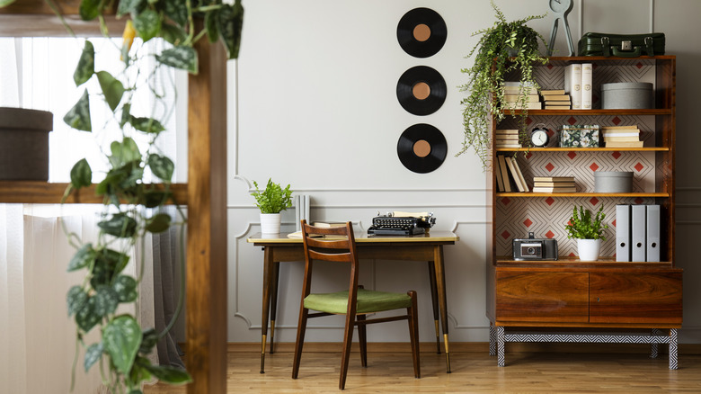 An office and living space with mid century modern furniture and decor