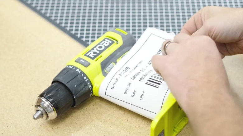 Repair person unpacking a broken Ryobi tool