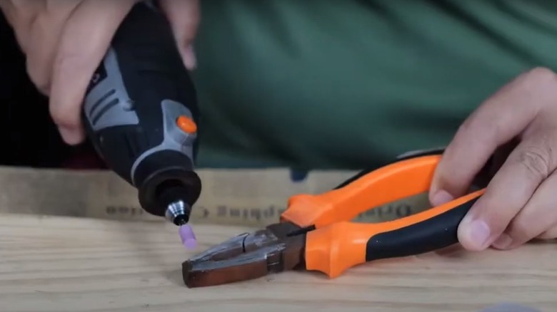 person using Tacklife rotary tool