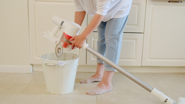 Person cleaning vacuum