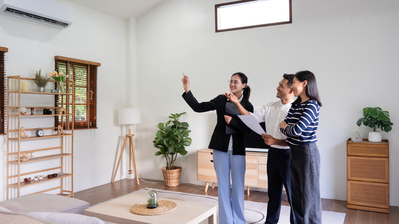 Real estate agent showing couple the inside of a house