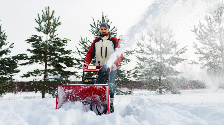 Man uses a snow blower