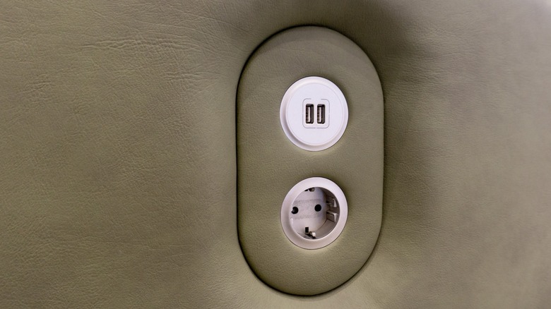 Close-up of a USB charging station on the side of a couch