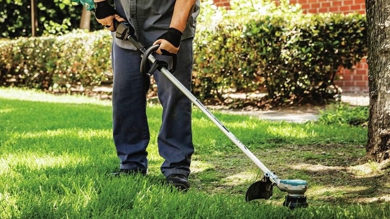 Man using a Makita string trimmer