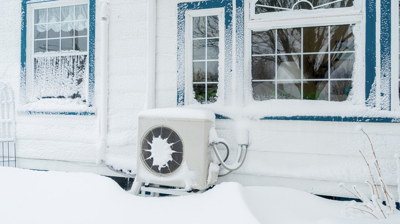 Heat pump outside a residential home in winter.