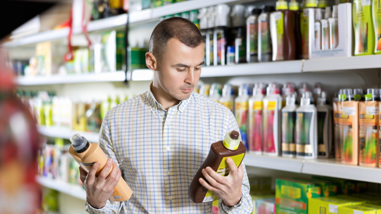 Man shopping for fertilizer in a store