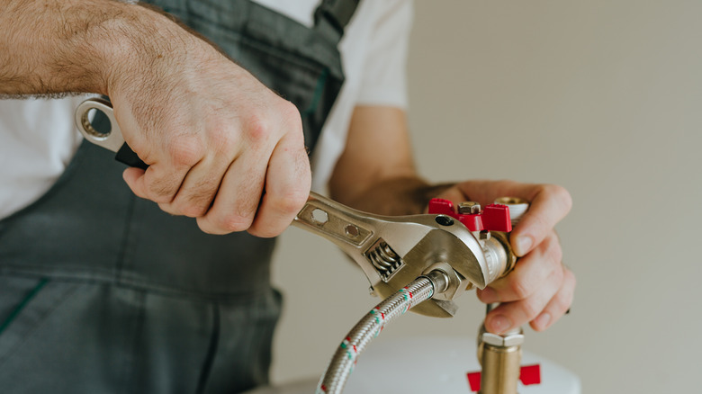 man installing water heater