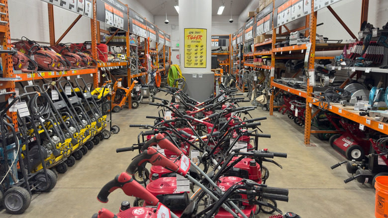 A variety of tools are shown in a Home Depot tool rental area