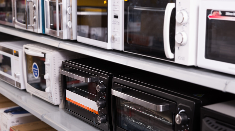 An assortment of microwaves for sale at a kitchen appliance store