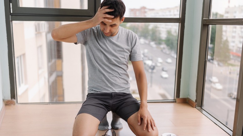 Frustrated man stares at floor