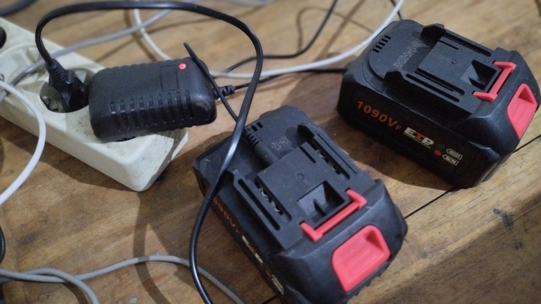 Charging black and red lithium power tool batteries with adapter