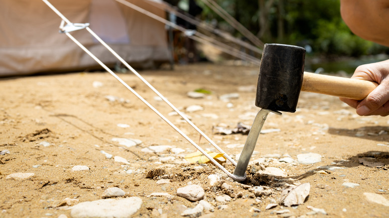 using mallet on metal stake