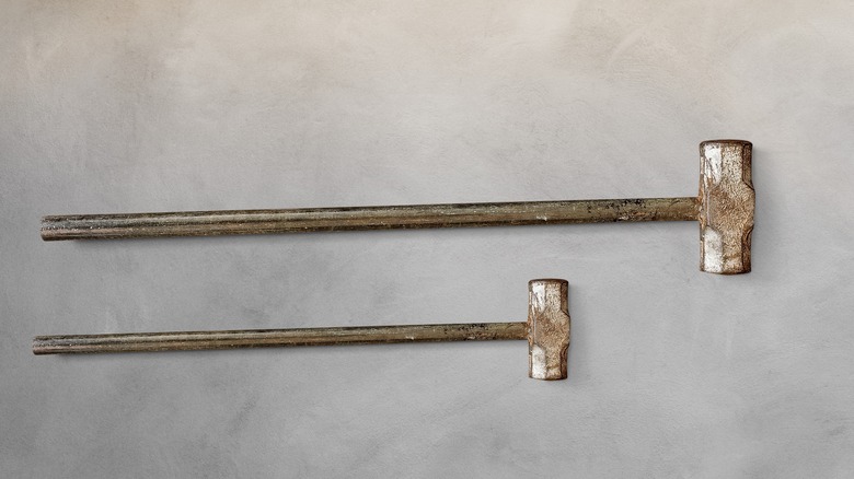 pair of sledgehammers on concrete