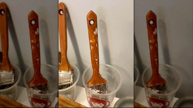Upcycled Wendy's plastic cups with paint brushes inside