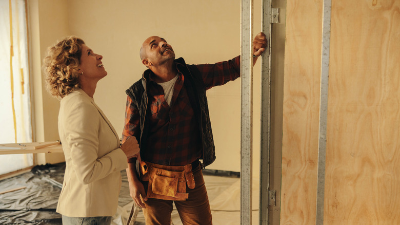 A homeowner discusses indoor renovations with a contractor.